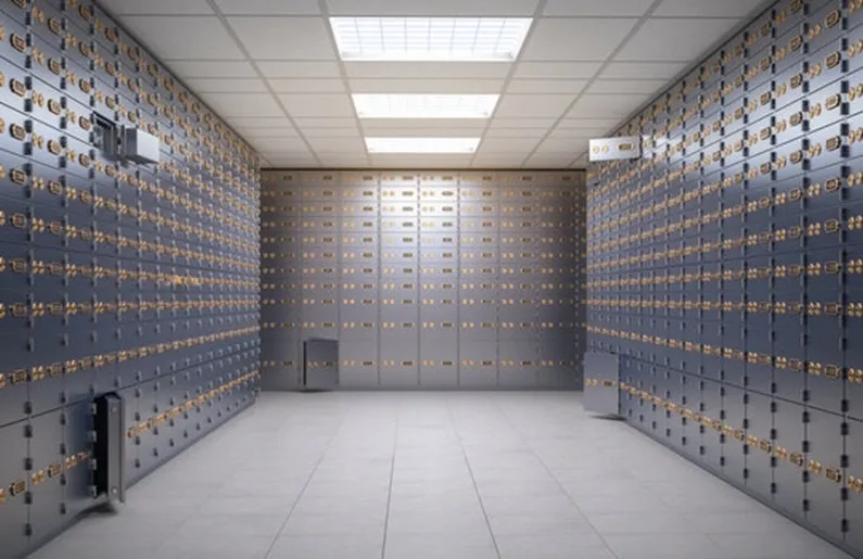 A bank vault lined with safe-deposit boxes.